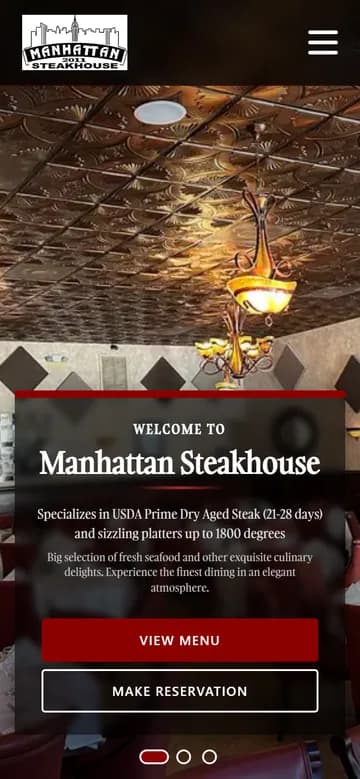 Manhattan Steakhouse website on a phone